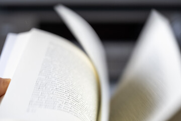 Dynamic close-up of book pages in motion with artistic blur. Conceptual image representing learning, storytelling, fast reading, curiosity and information flow.