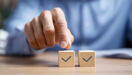Finger points to wooden cube with check mark symbol.