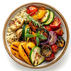 Overhead view of a bowl filled with couscous and various grilled vegetables inside it