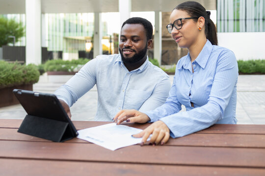 Business team collaborating in modern city setting