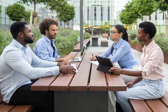 Business team meeting outdoors in urban setting