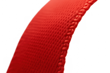 Close up of red woven textile strap with textured surface and visible threads, featuring a braided edge on transparent background