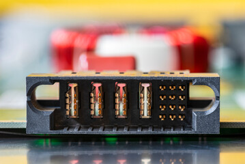 Electrical power socket on a printed circuit board with electronics in blurred background