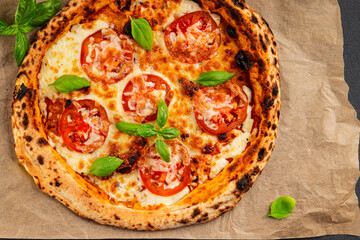 Pizza tomato margarita fast food natural product tasty snack fresh delicious gourmet food background on the table rustic top view copy space