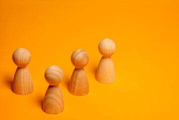 Wooden peg doll figures representing a team or community on orange