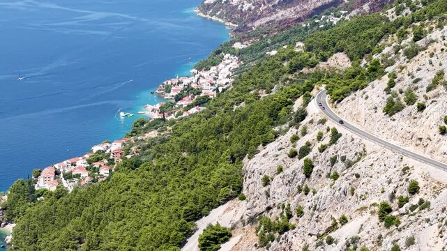 Breathtaking View of a Picturesque Croatian Resort Village Along the Dalmatian Coastline, Featuring Red-Roofed Houses, Sandy Beaches, and Sparkling Turquoise Waters.