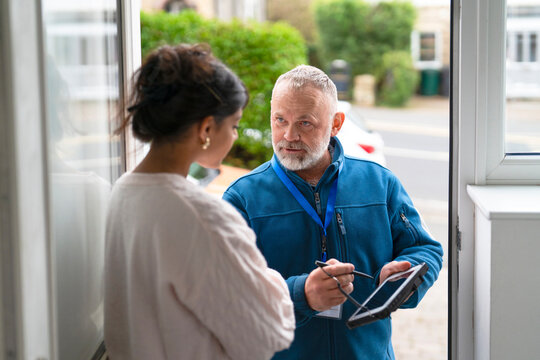 Door-to-door conversation between a man and a woman in a residential neighborhood on a sunny afternoon