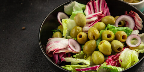 Salad olives, green leaf lettuce, vegetables natural product tasty snack fresh delicious gourmet food background on the table rustic top view copy space keto and paleo diet vegan and vegan food