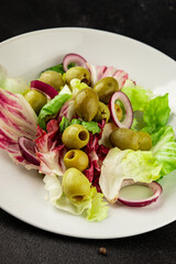 Salad olives, green leaf lettuce, vegetables natural product tasty snack fresh delicious gourmet food background on the table rustic top view copy space keto and paleo diet vegan and vegan food