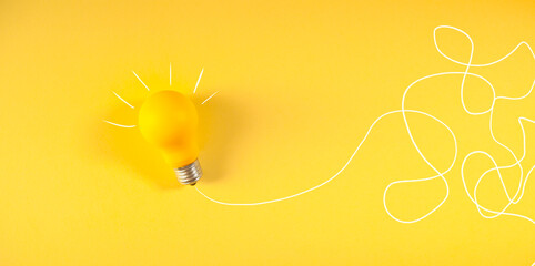 Light bulb on a yellow background. Creative idea concept.