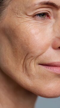 Detailed close-up of a mature woman's facial features showcasing natural skin texture and expressions in soft lighting