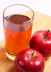 apple juice from red apples on the table.. Vertical photo format