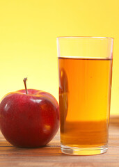 apple juice from red apples on the table.. Vertical photo format