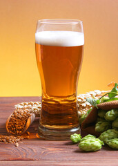 Beer, wheat and hops on the table.. Vertical photo format