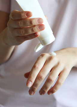 girl smears her hands cosmetic cream. skin care,. Vertical photo format