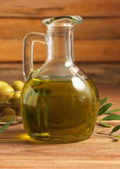 olive oil, green leaves and olives on the table.. Vertical photo format