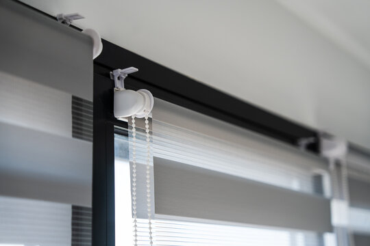 Close up of roller mechanism and chain system of modern zebra blinds in bright minimal interior