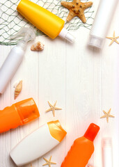 sunscreens on a colored background. Protection of the skin. Vertical photo format