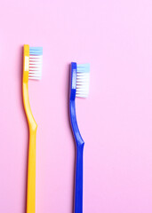 Toothbrushes on a colored background top view. Oral hygiene.. Vertical photo format