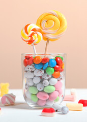 various candy and sweets on the table on a colored background.. Vertical photo format
