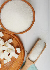 white sugar on the table on a light background close-up. Vertical photo format