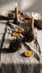 Minimalist Table Setup with Linen, Pinecones, Candles, and Dried Citrus Slices