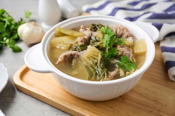 Pickled Lettuce Soup with Pork Rips in white bowl