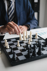 Naklejka premium businessman moves chess pieces to execute winning business strategy