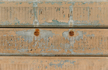 Rusty textured metal surface with peeling paint and corrosion