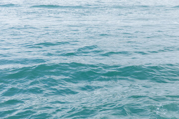 Calm ocean waves with tranquil blue water surface in daylight