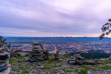 Beautiful evening view of a city from a mountain with natural stone formations