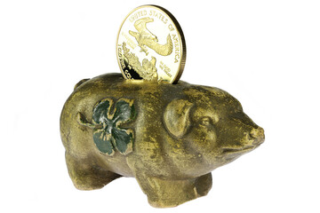 antique piggy bank with 1 ounce American gold eagle bullion coin isolated on white background