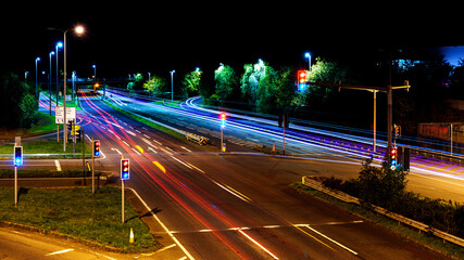 City traffic lights creating dynamic trails on urban road at night