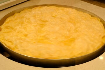 A close-up of water pastry being baked in a pastry shop. Turkish cuisine pastries. Ramadan iftar and sahur menu.