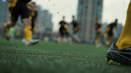 Player practices skills on a city field during a sunny afternoon with teammates nearby - Powered by Adobe