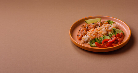 A food bowl with salmon, rice, avocado, tomatoes, and cucumbers. A salmon bowl