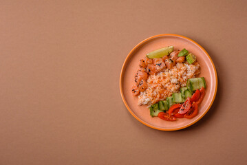 A food bowl with salmon, rice, avocado, tomatoes, and cucumbers. A salmon bowl