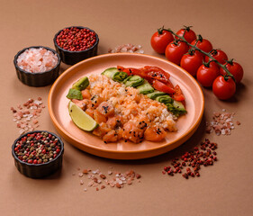 A food bowl with salmon, rice, avocado, tomatoes, and cucumbers. A salmon bowl