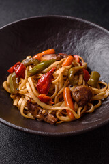 Asian food, noodles with vegetables, vegetarian dish with spicy sauce. Noodles with vegetables