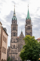 Fototapeta premium Gothic St. Lorenz Church in Nuremberg, Germany, beautifully restored after World War II, featuring stunning stained glass, grand organ, and medieval architecture.