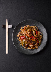 Asian food, noodles with vegetables, vegetarian dish with spicy sauce. Noodles with vegetables