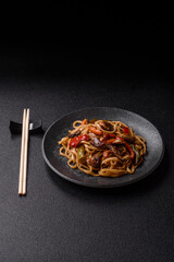 Asian food, noodles with vegetables, vegetarian dish with spicy sauce. Noodles with vegetables
