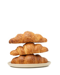 Three croissants in a plate on a white isolated background