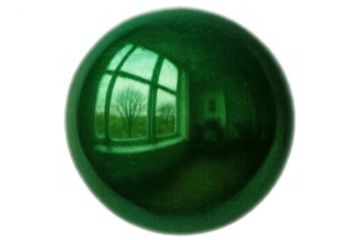 Green sphere reflecting a tree and window, shiny glass orb, environment concentration and earth concepts