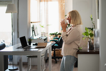 Senior woman relaxing during home office coffee break