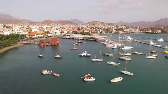 CAPE VERDE - 9.4.2025 - Very good aerial footage approaching a port with sailboats docked in Mindelo, Cape Verde.