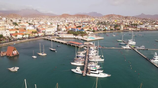CAPE VERDE - 9.4.2025 - Great aerial footage starting to circle a port with sailboats docked in Mindelo, Cape Verde.