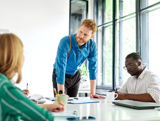 Obraz premium Group of young business people having a meeting or presentation and seminar with whiteboard in the office. Portrait of a young business man leader