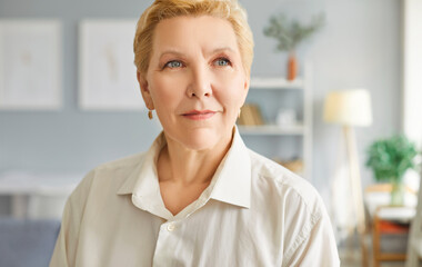 Smiling thinking pensive senior woman casual portrait at home, thoughtful face of elderly female...