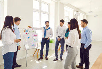 Businessman leads a dynamic meeting, presentation, or briefing for team in the office. Effective...